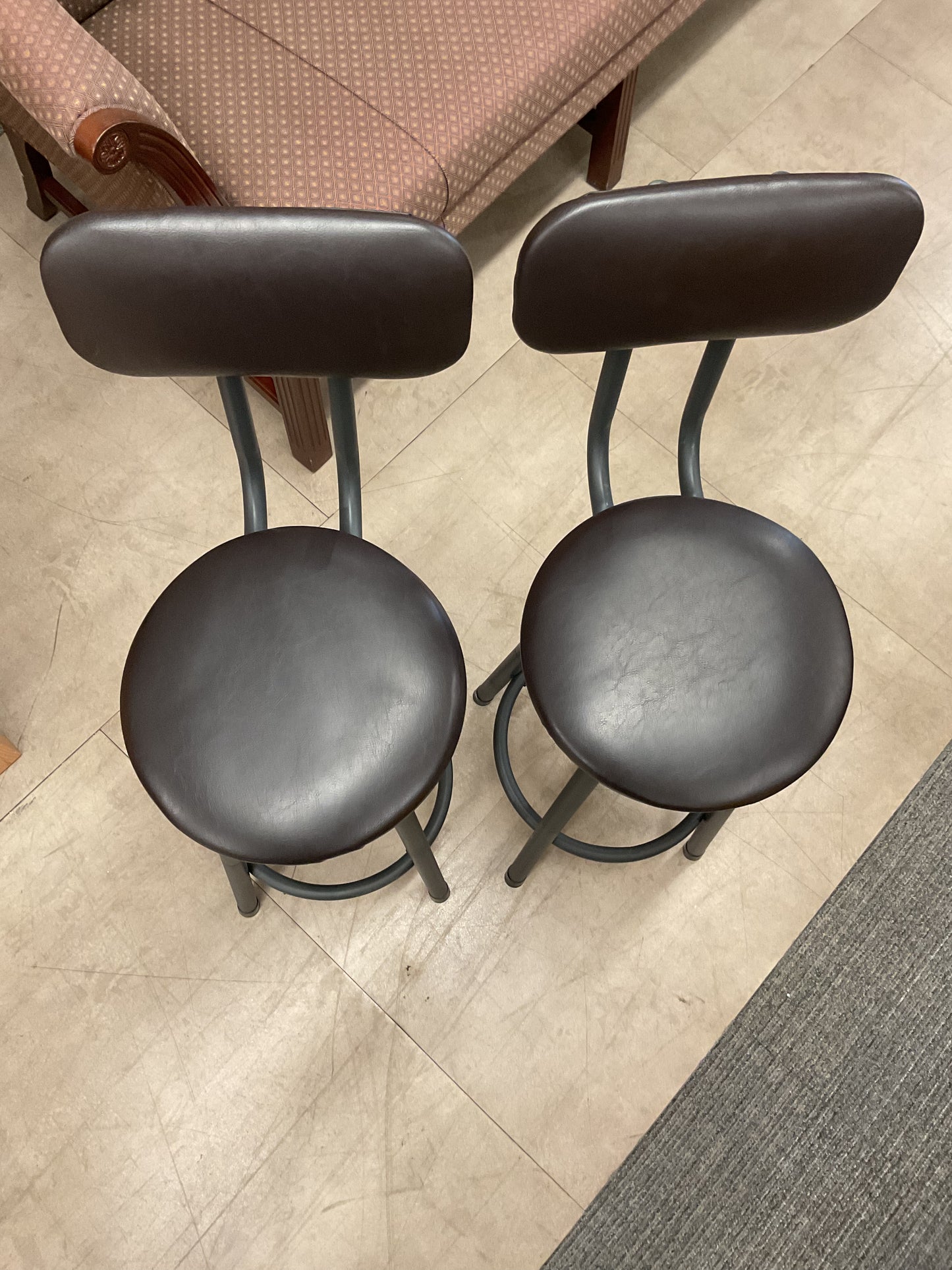 Pair of dark bar stools with backs